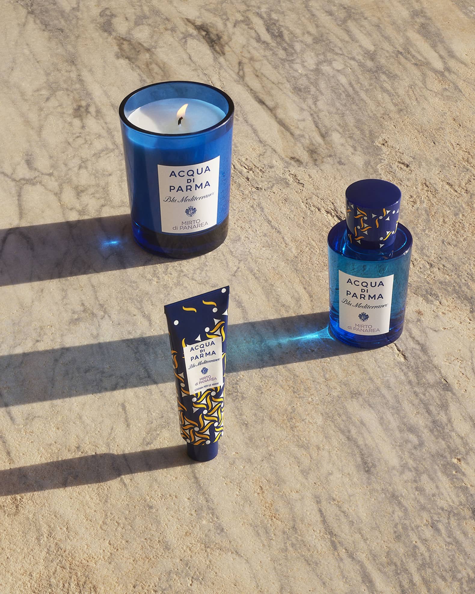 Bottle and candle in blue glass