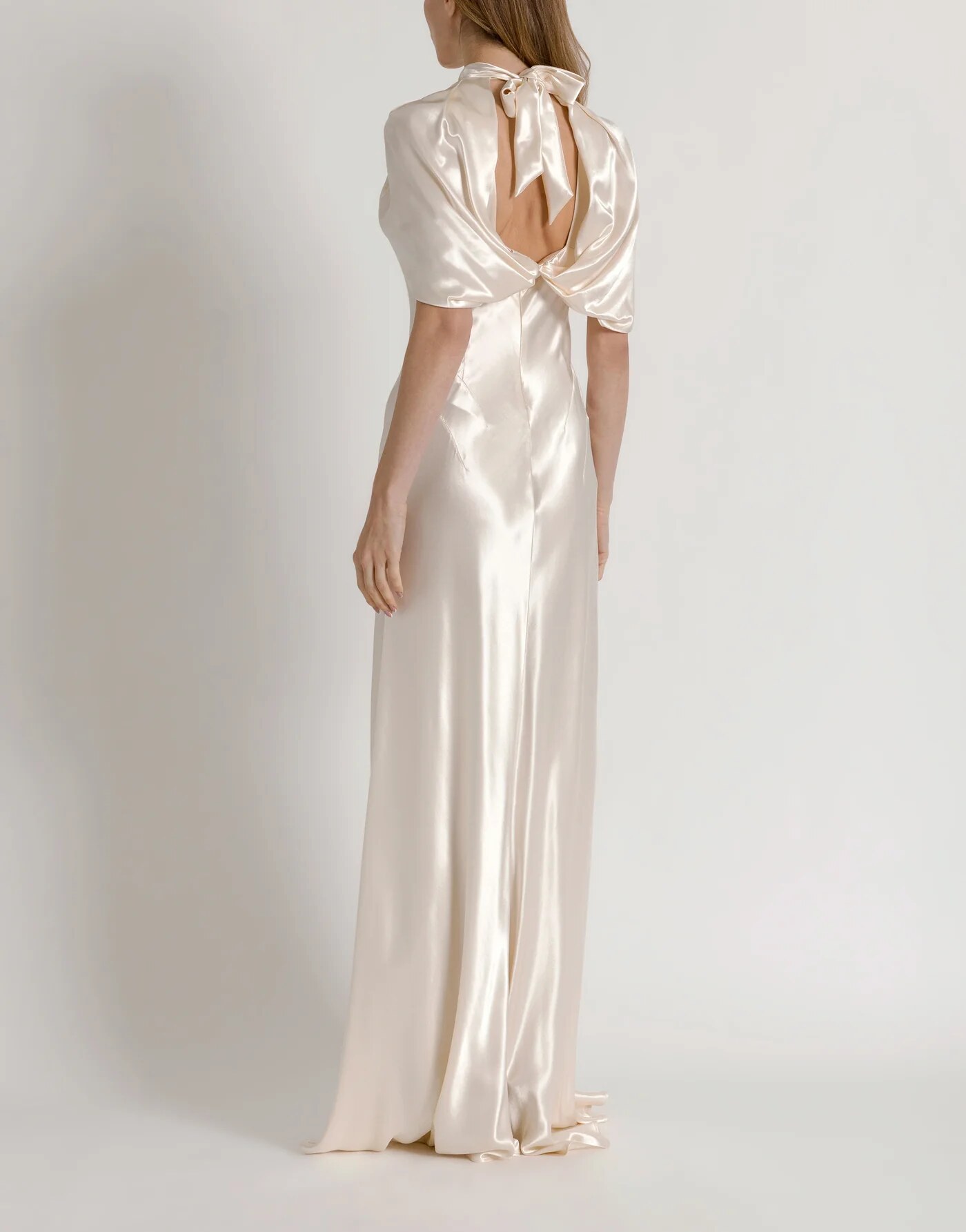 Satin evening dress with cape sleeves — profile view