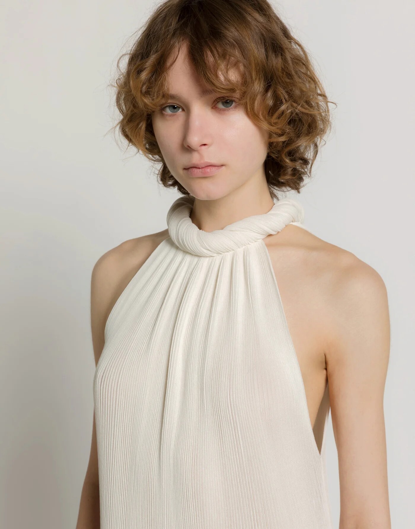 Long plissé knit dress — profile view