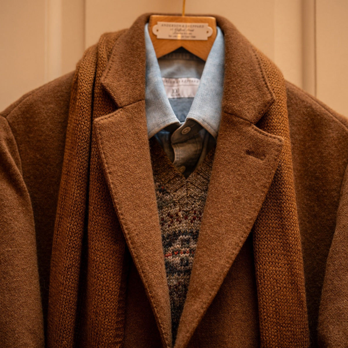 Shirt layered under brown outerwear