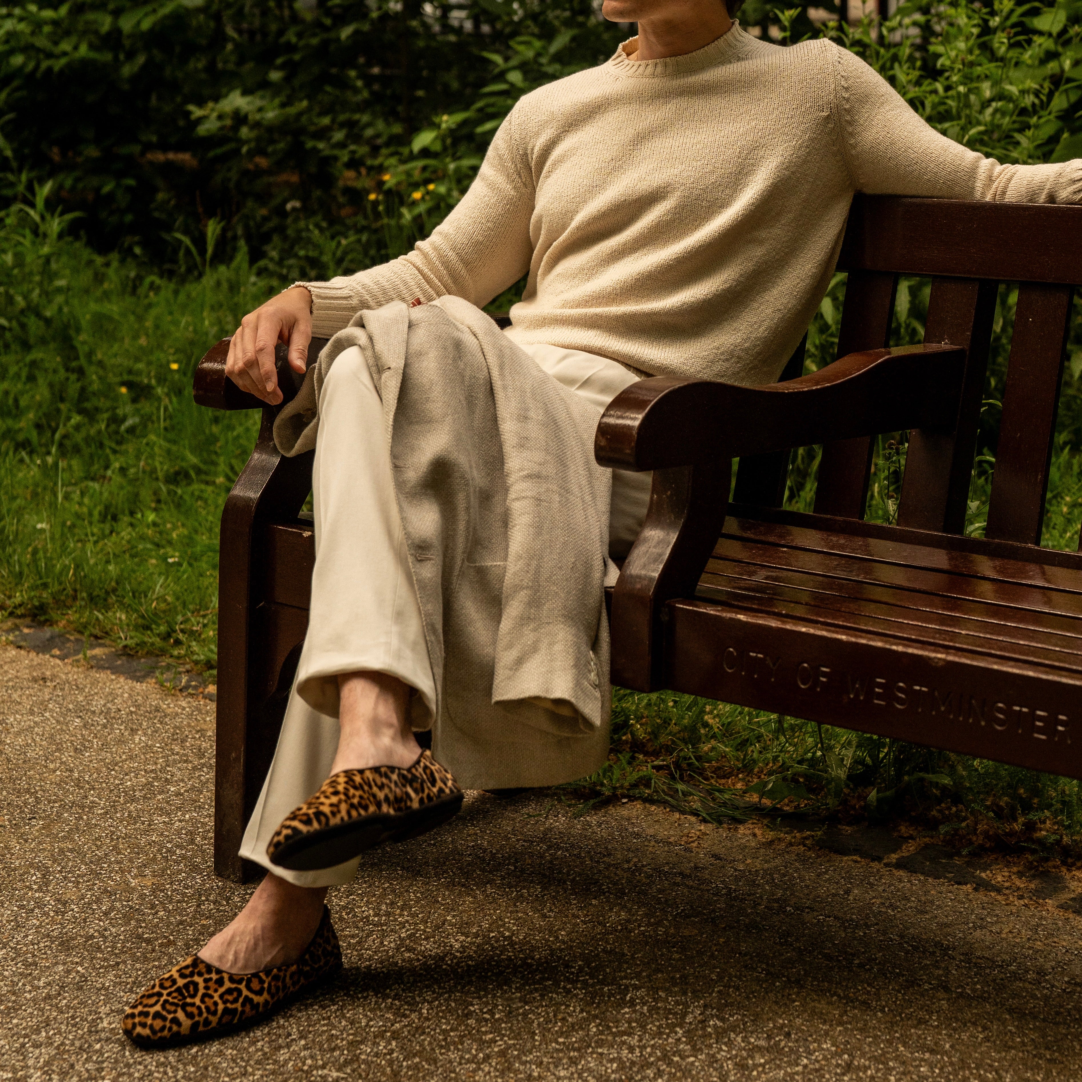 Slippers worn with cream trousers