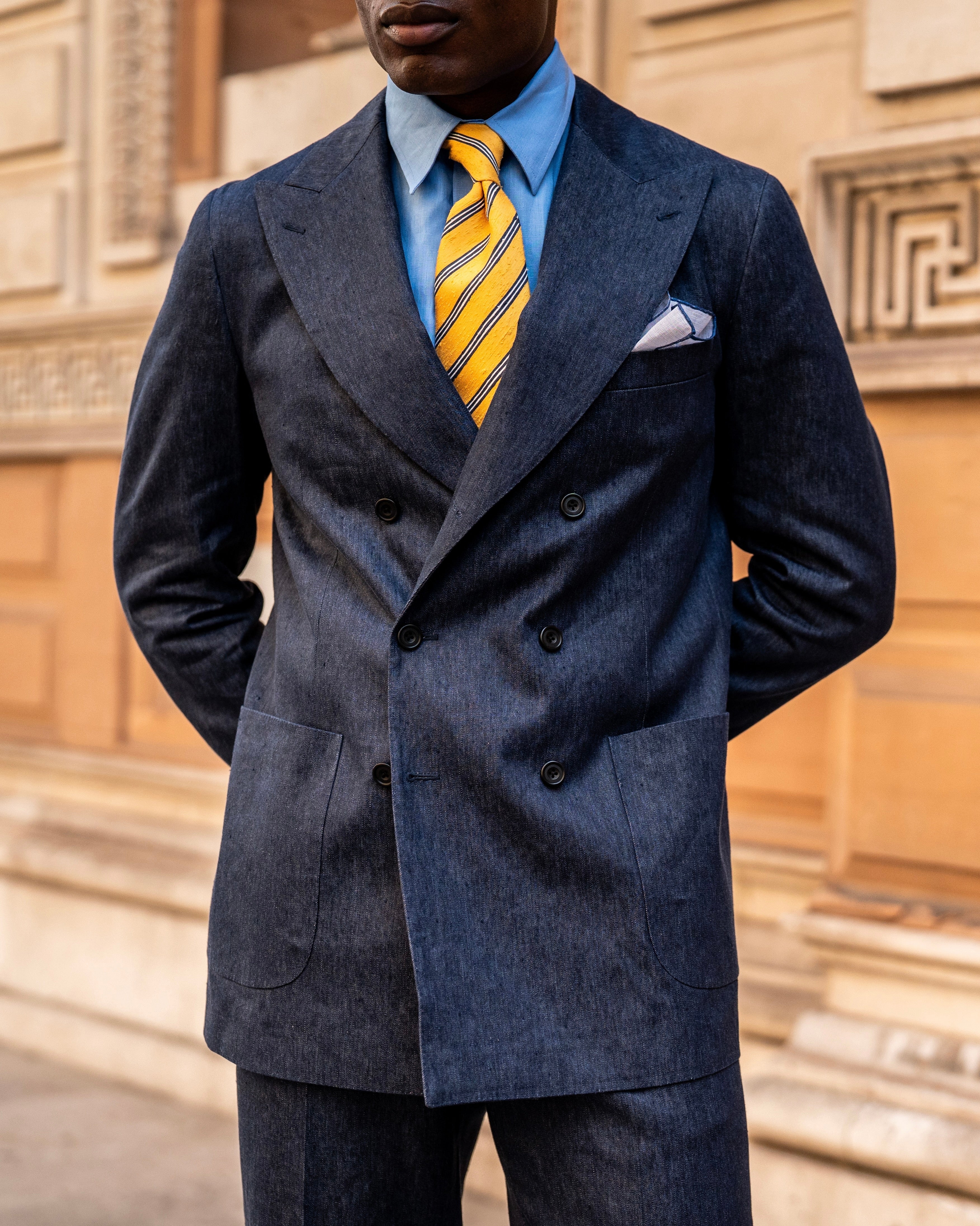 Suit worn with open shirt and soft shoulder line
