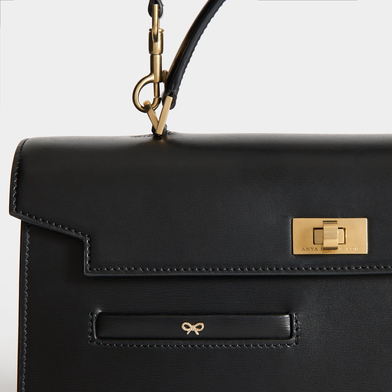 Front pocket and gold hardware detail
