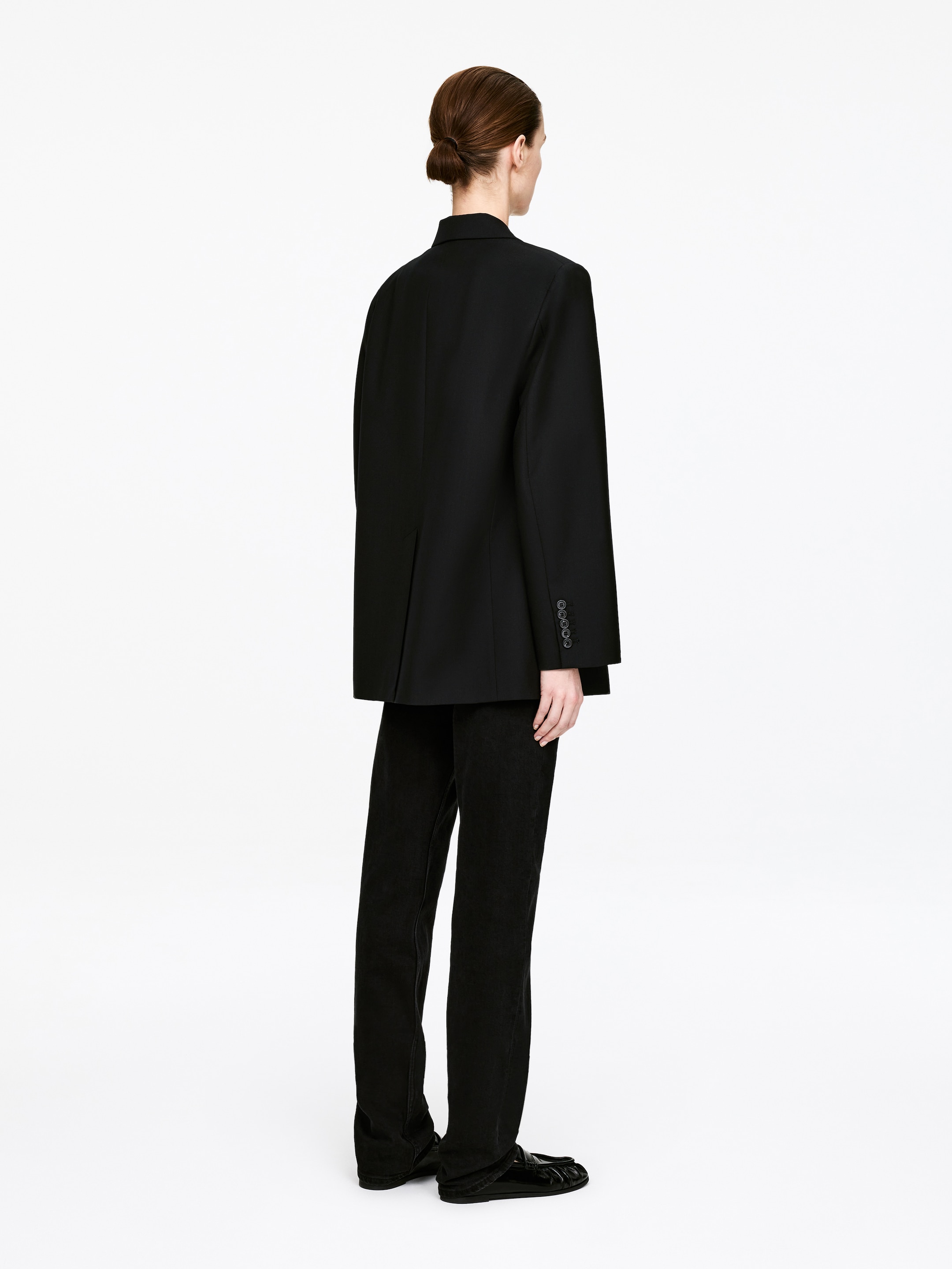 Three-quarter view of the black blazer
