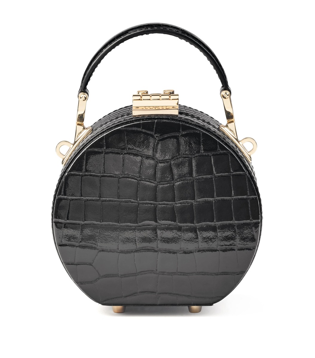 Round black croc profile