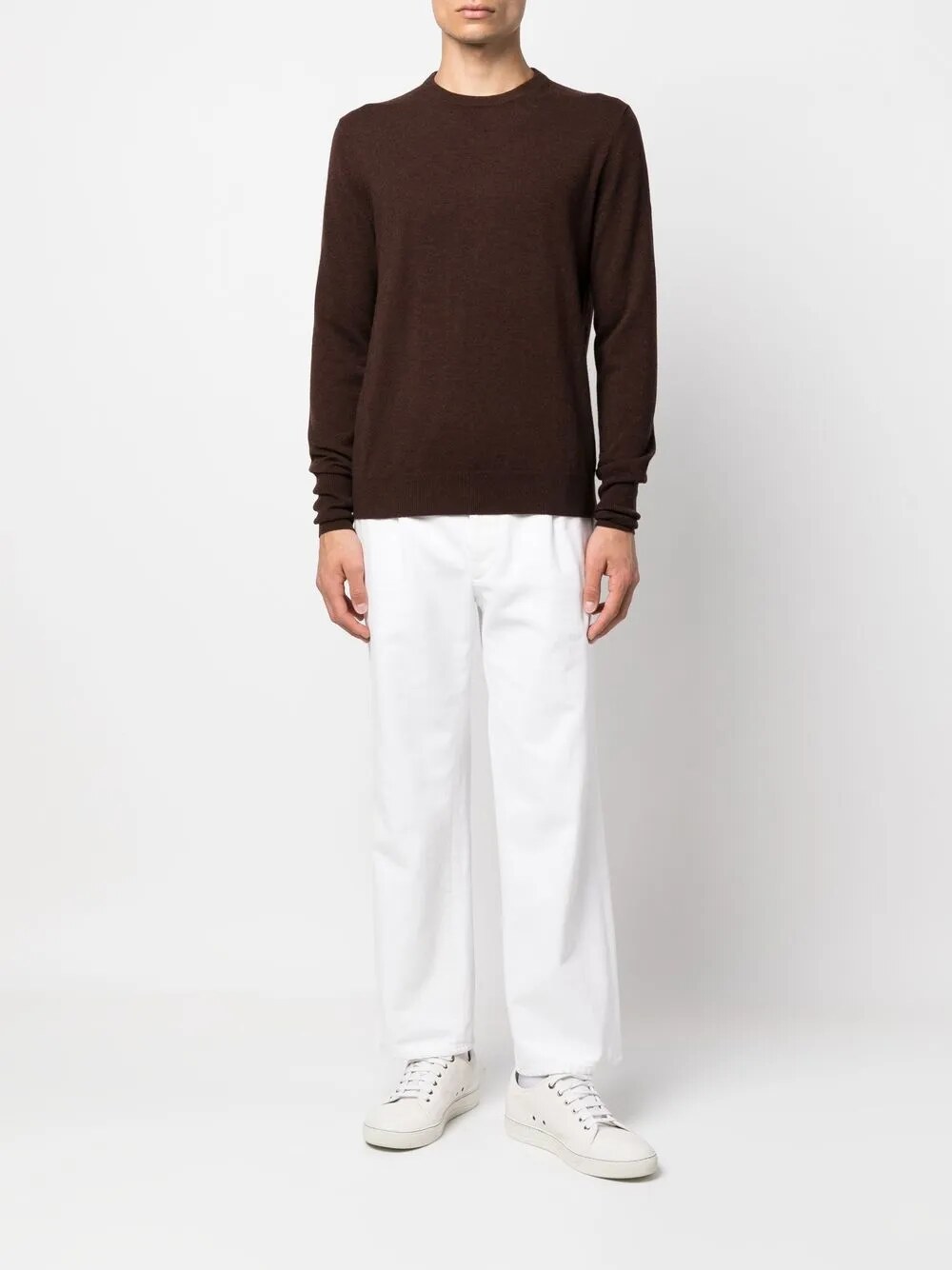 Brown crew-neck jumper worn with white trousers