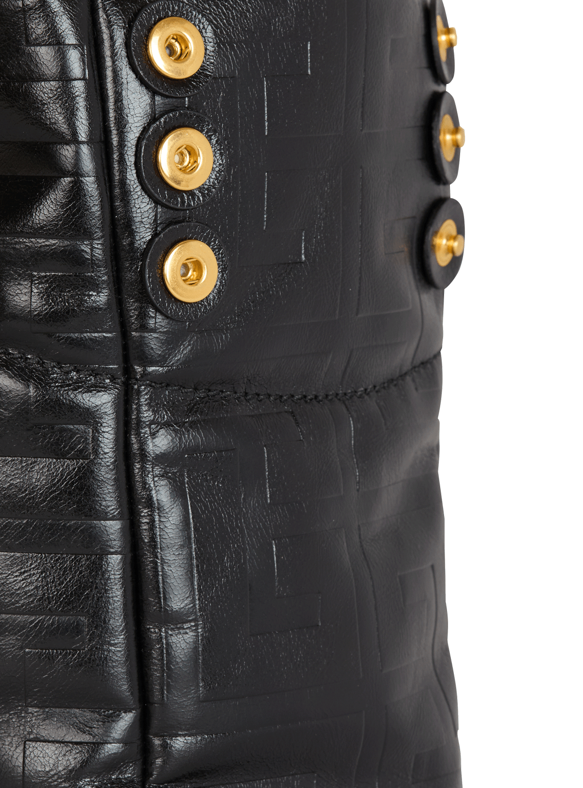 Side detail — gold studs and the embossed monogram leather