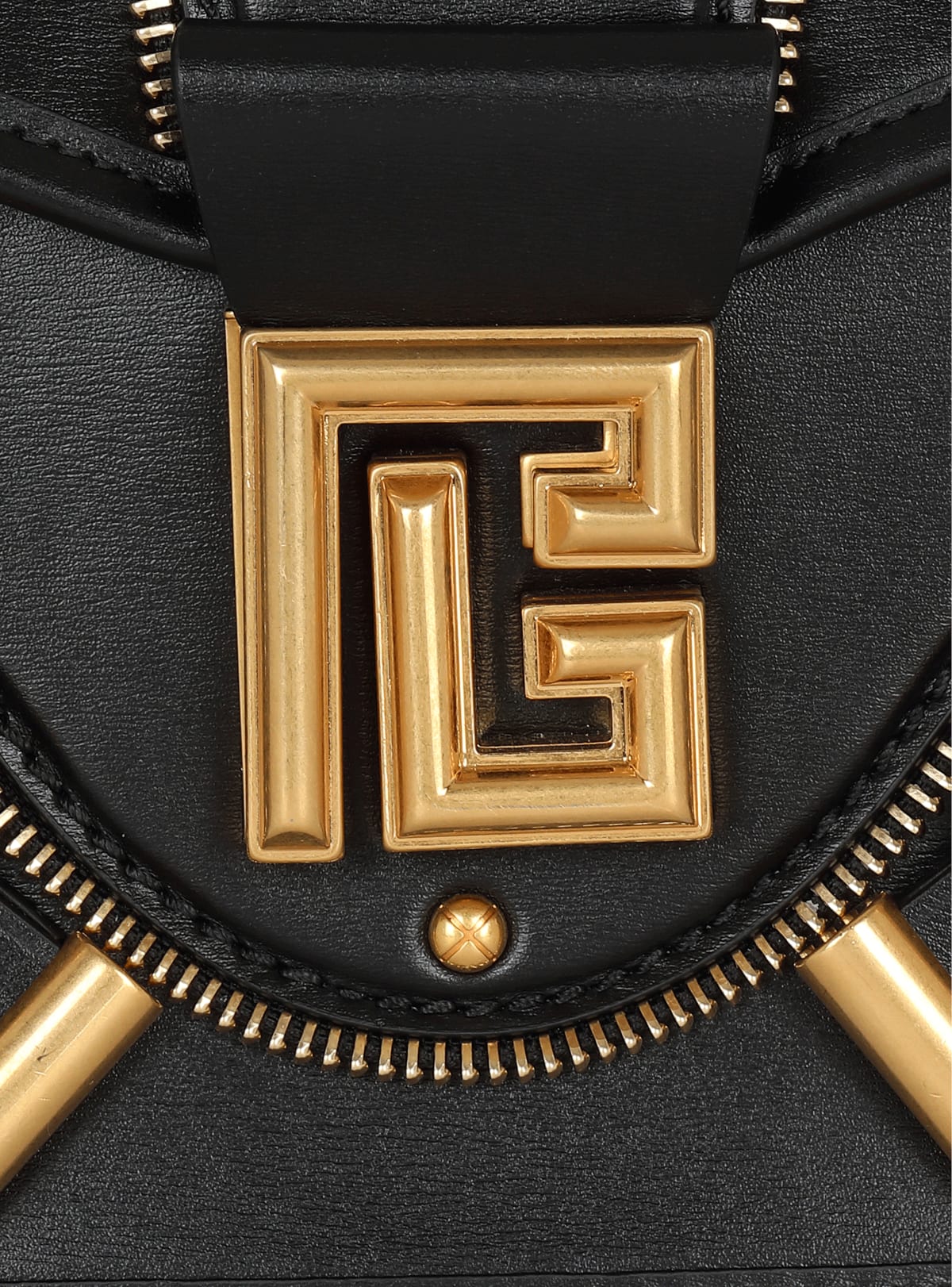 Macro of the gold PB labyrinth monogram plaque