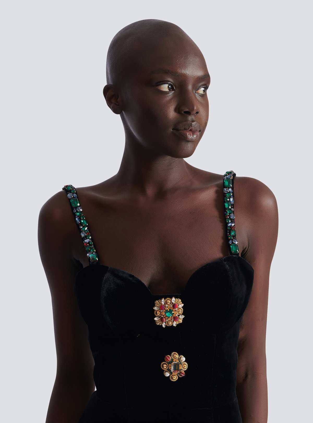 Bust detail of the gold-and-gemstone embellished medallions