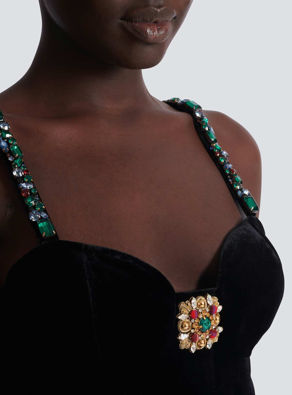 Macro of the crystal-set straps and jewelled brooch detail