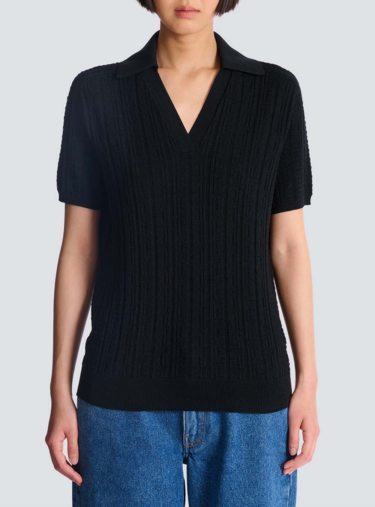 Worn front — the V-neck polo silhouette