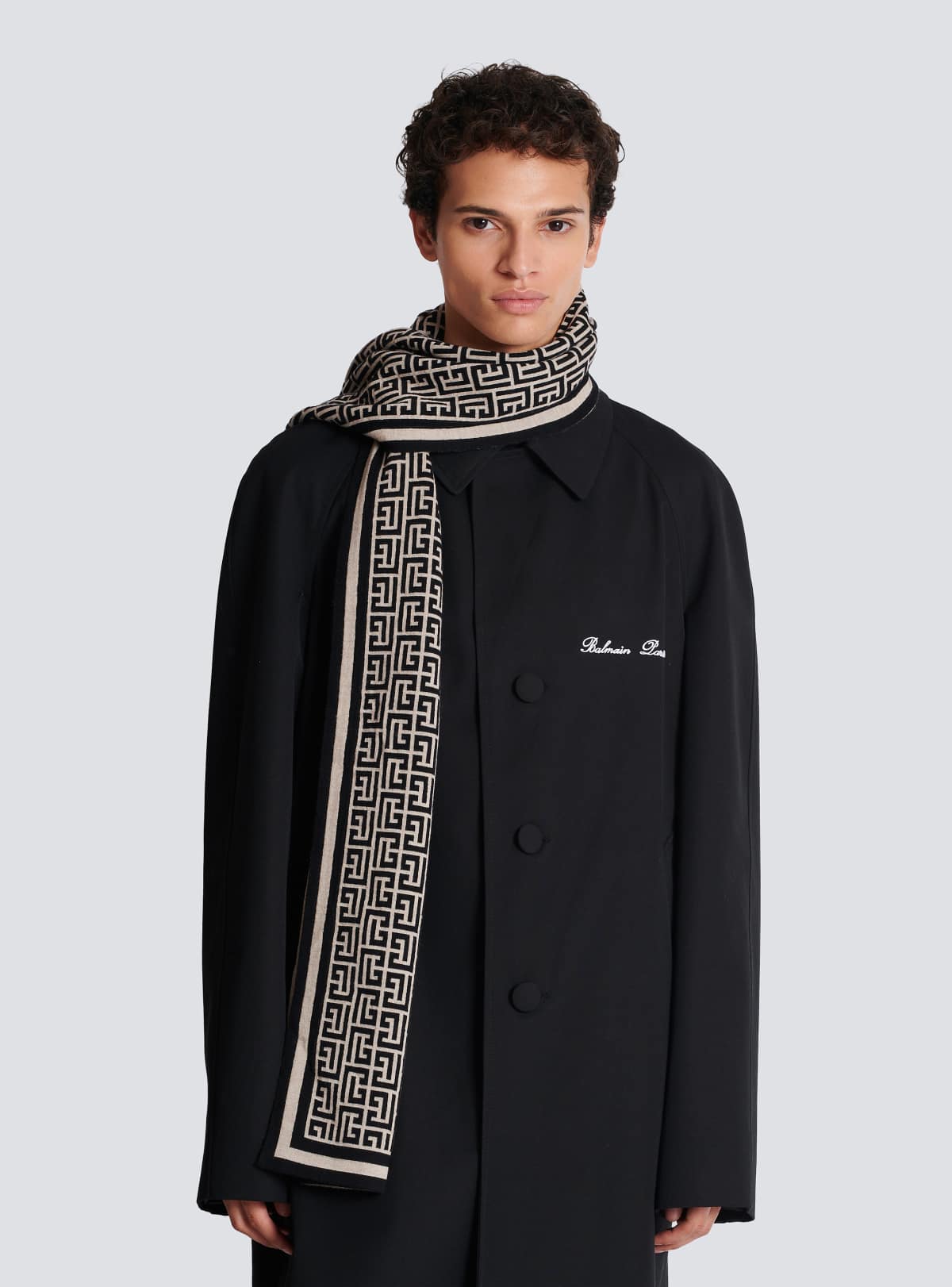 Worn around the neck over a Balmain Paris coat