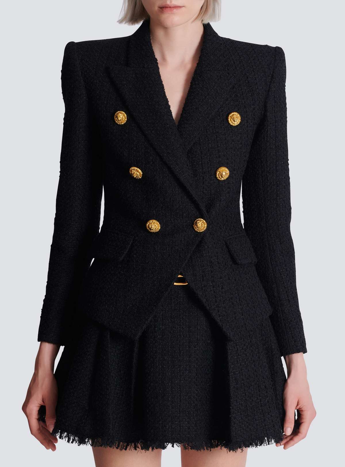 Worn front — the sharp shoulders and nipped waist