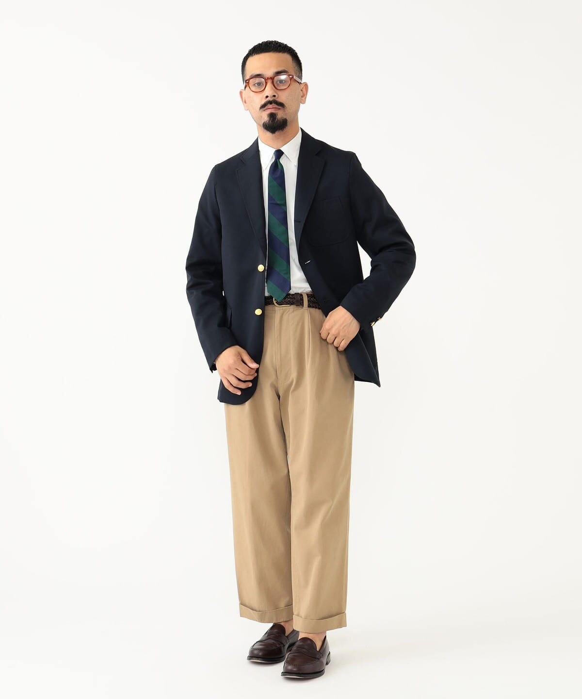Blazer worn with tie and pleated trousers