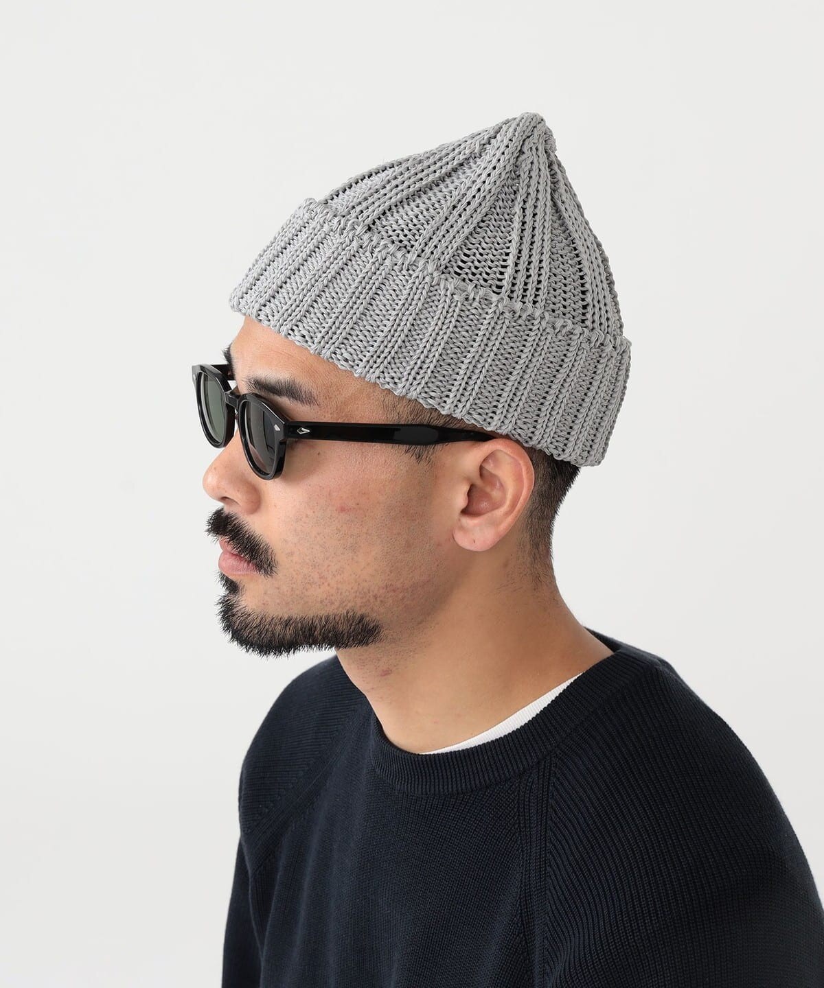 Grey watch cap worn on head
