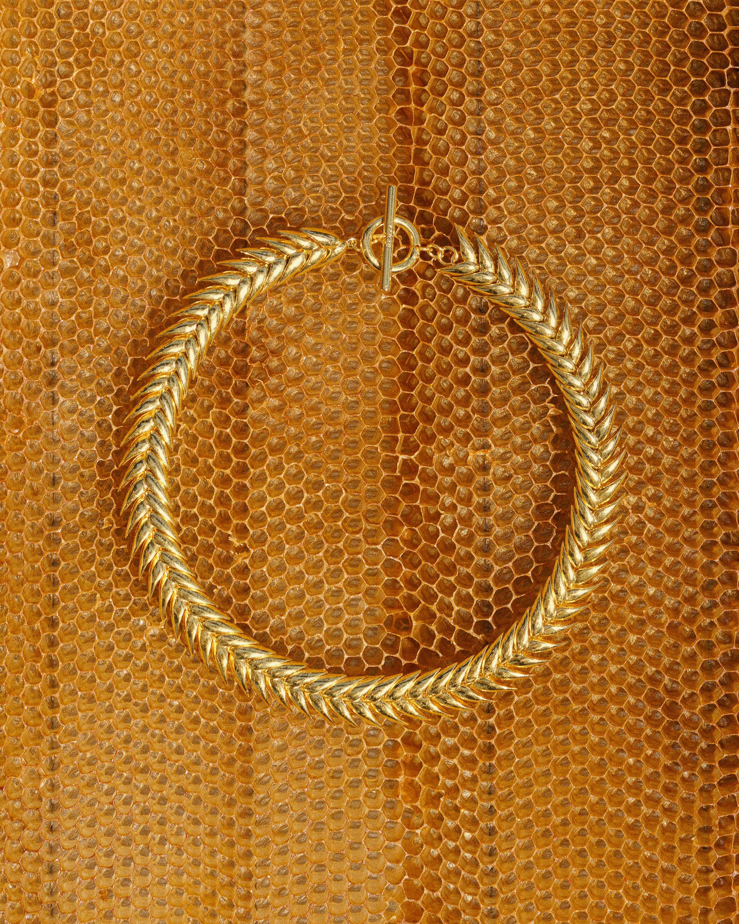 Necklace worn with a black square-neck top