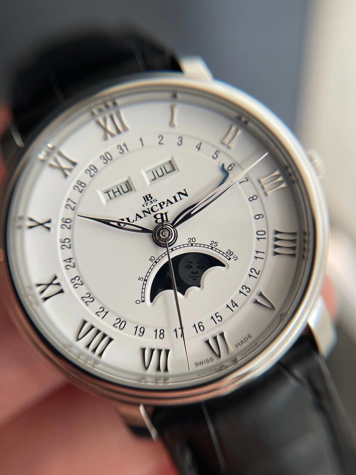 Wrist closeup of the moon-phase and calendar dial