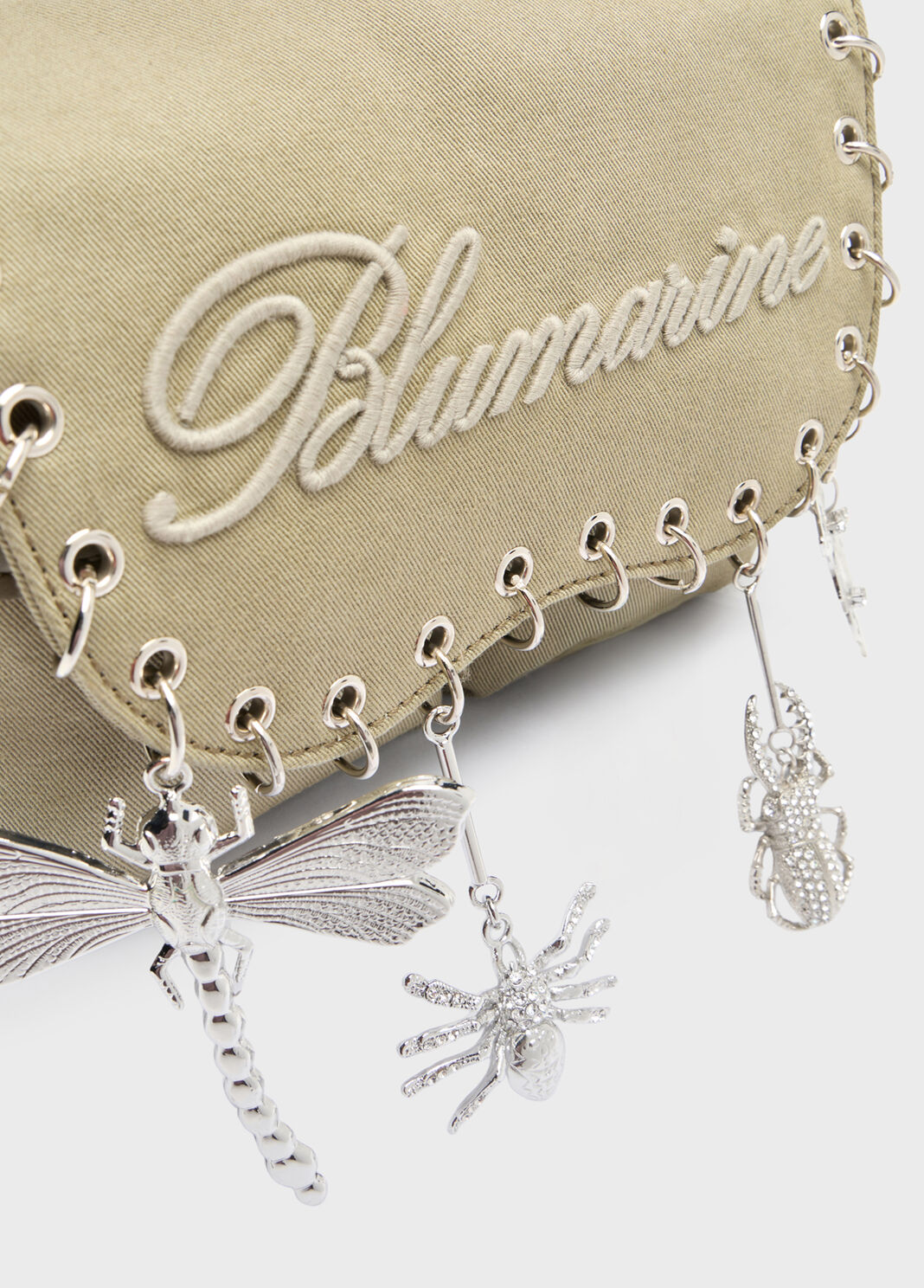 close crop on embroidered logo and metal charms