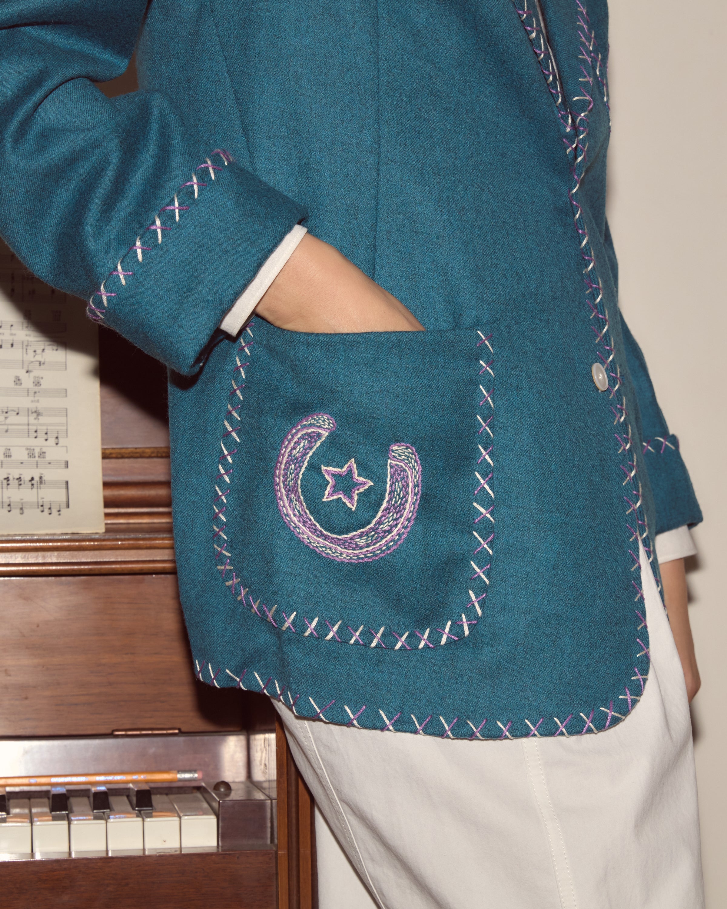 Cross-stitched edge detail and embroidered pockets