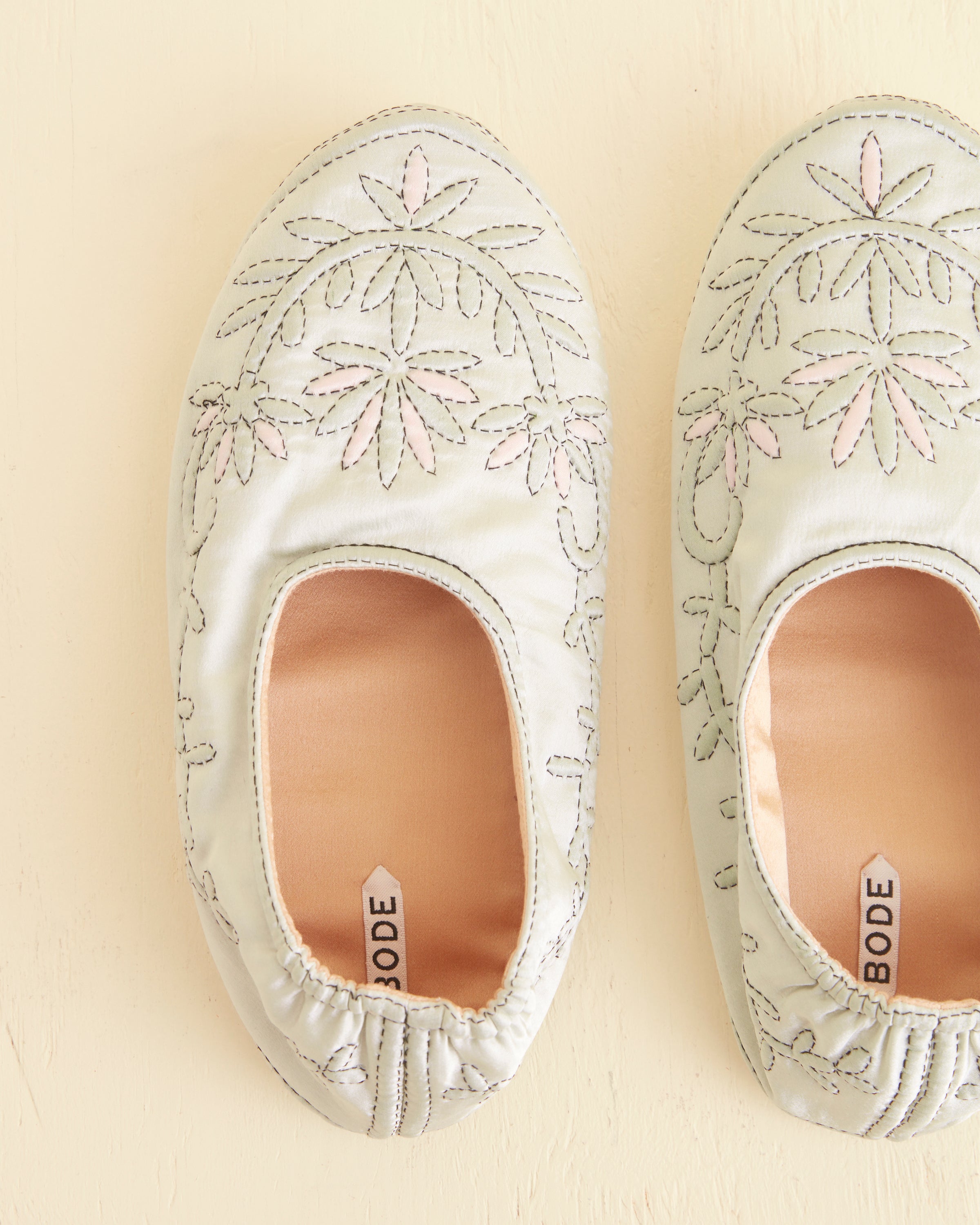 Pair view with green-and-pink embroidery
