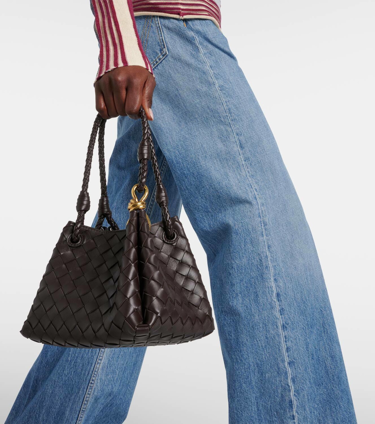 Mini in dark brown, carried by the braided top handles