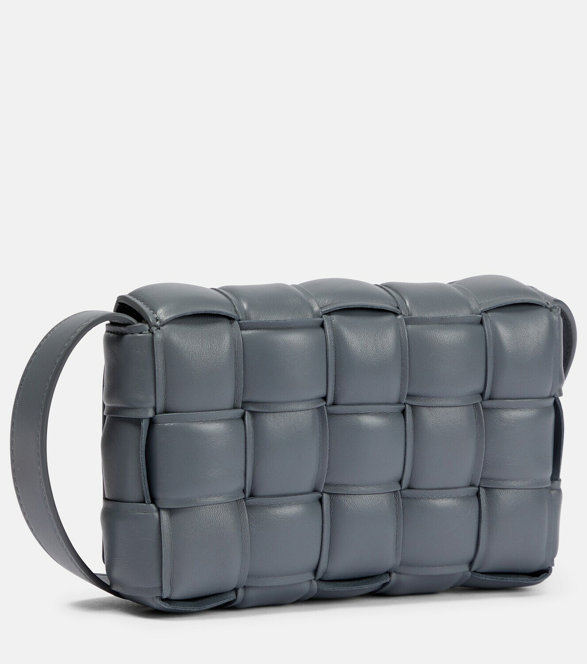 Slate-grey three-quarter angle showing the puffed leather cushions