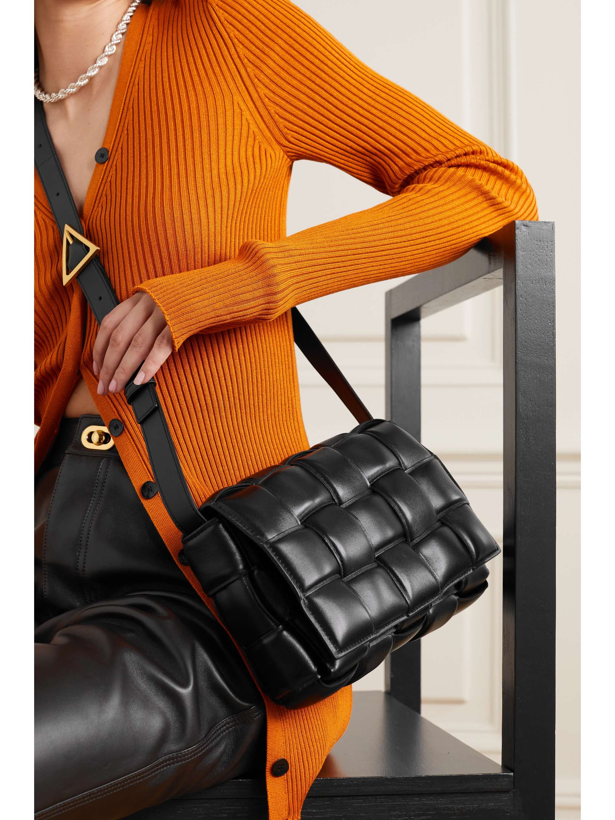 Black, carried crossbody on the woven leather strap