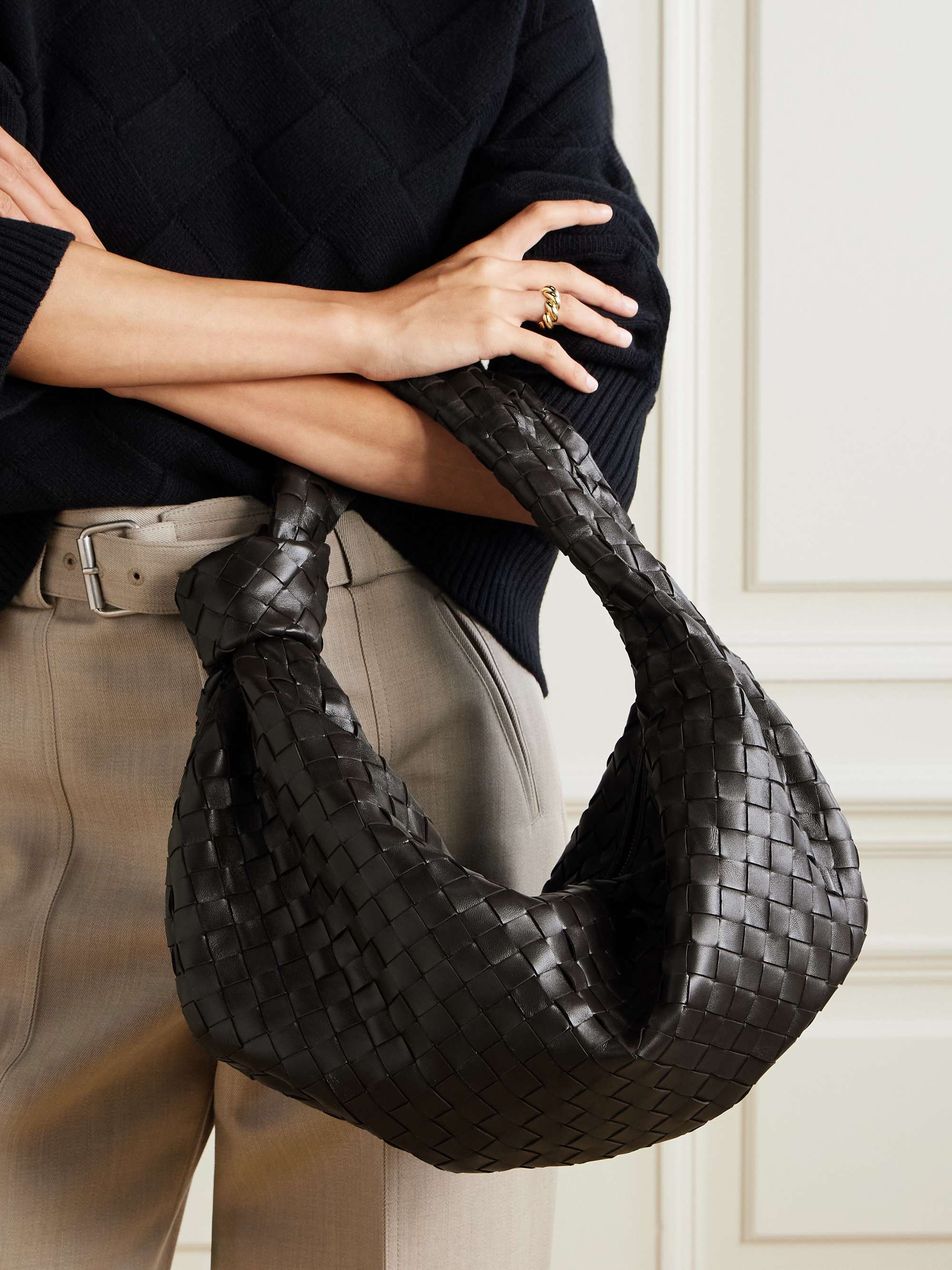 Small carried on the shoulder, the woven body slouching under the arm