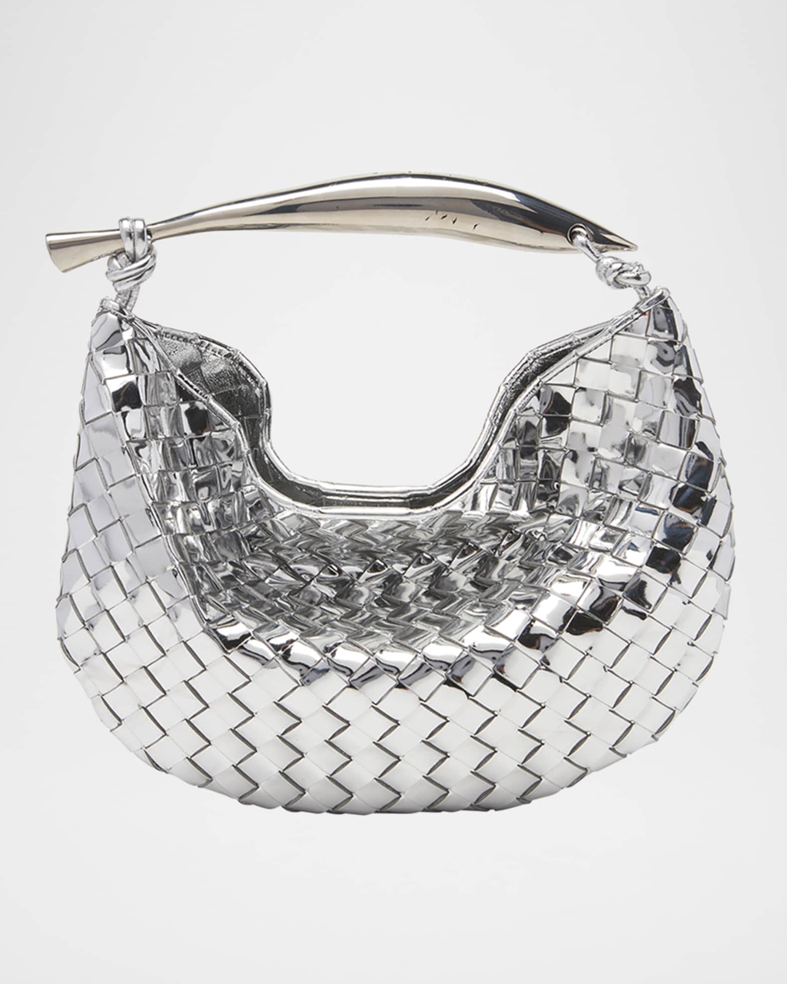 Mirror-silver — the curved sardine handle knotted to the woven body
