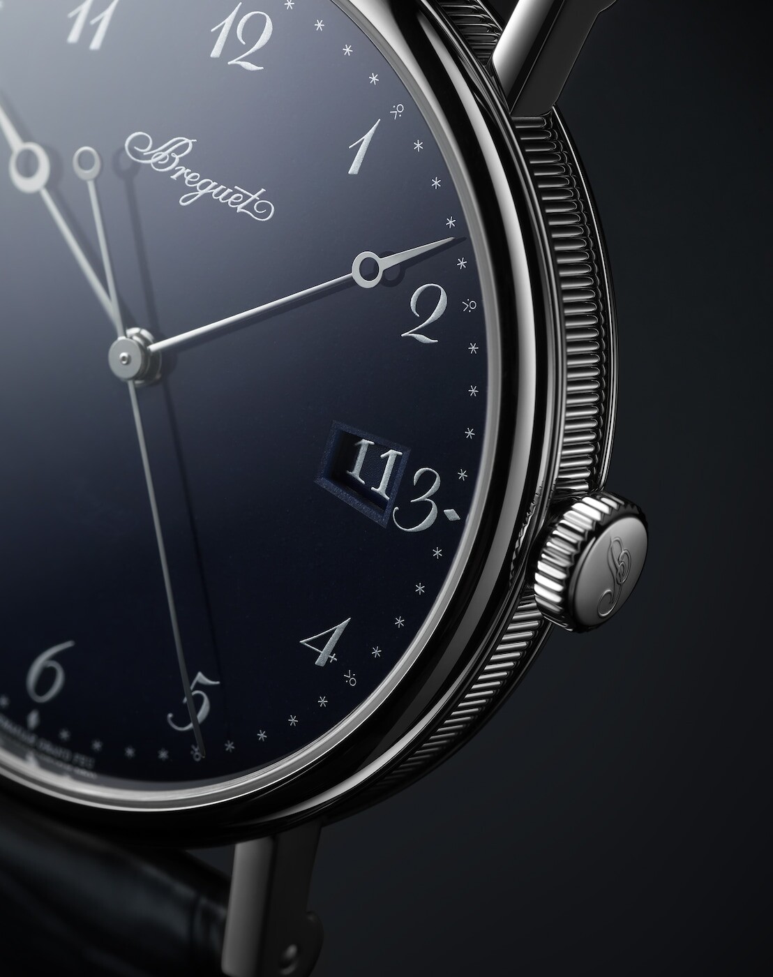 Close view of the dial, date aperture and fluted case band