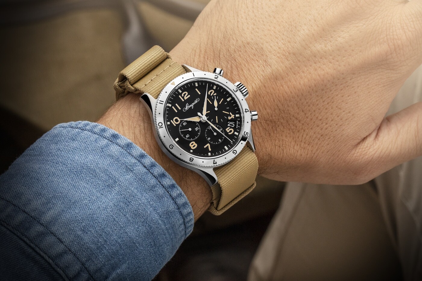 The 2067 shown on a strap against brushed metal