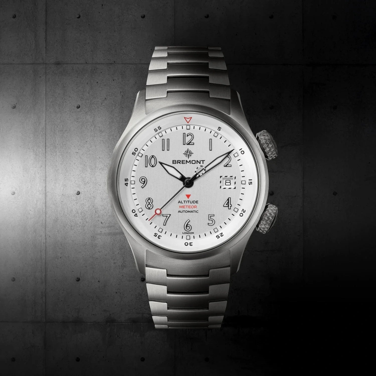 Silver dial on leather strap showing the dual-crown profile