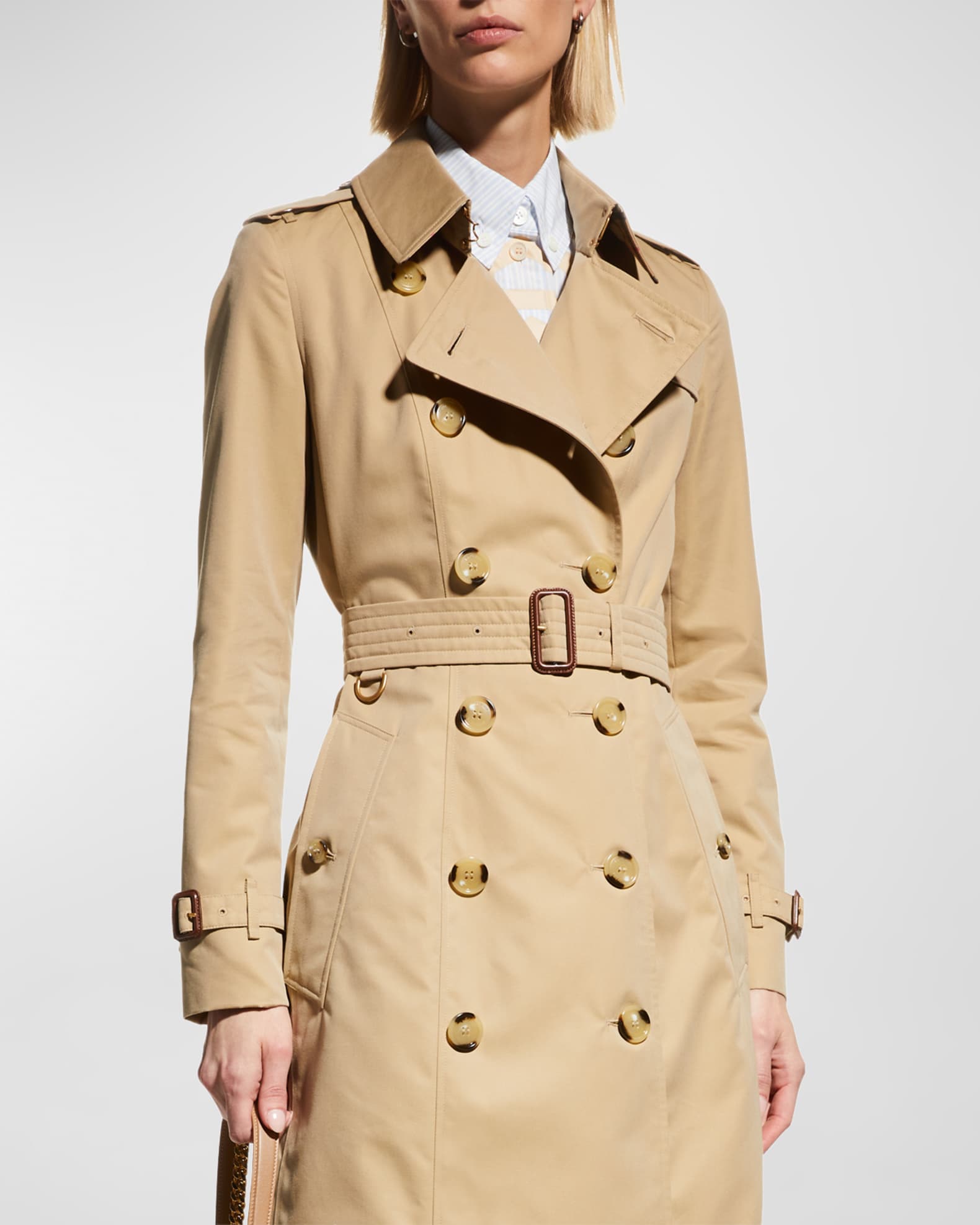 Front detail — double-breasted closure, storm shield and belt buckle