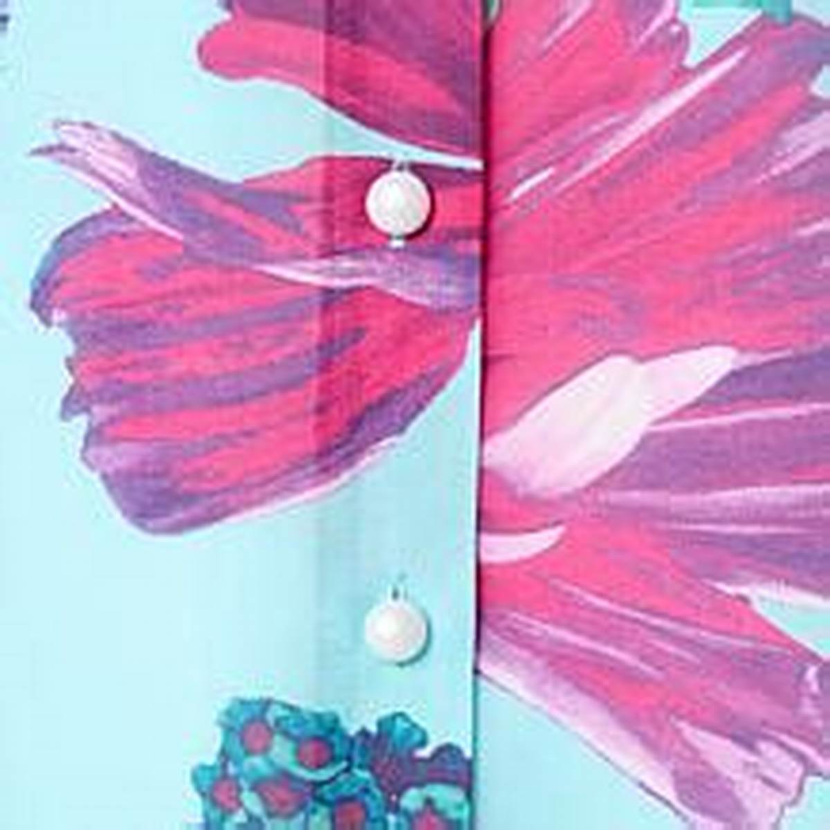 Close-up of the bold floral print and buttons