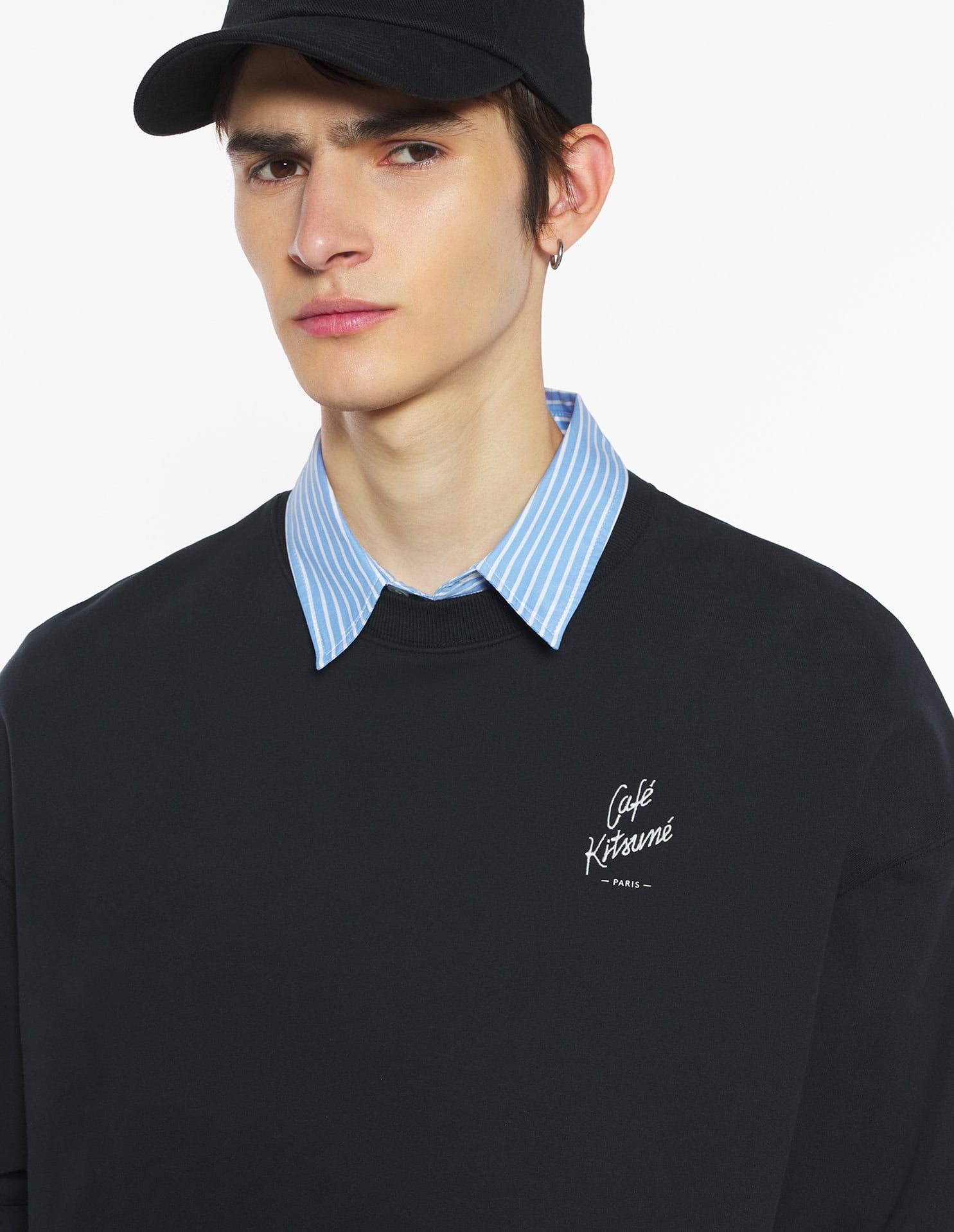 Black sweatshirt styled with shirt