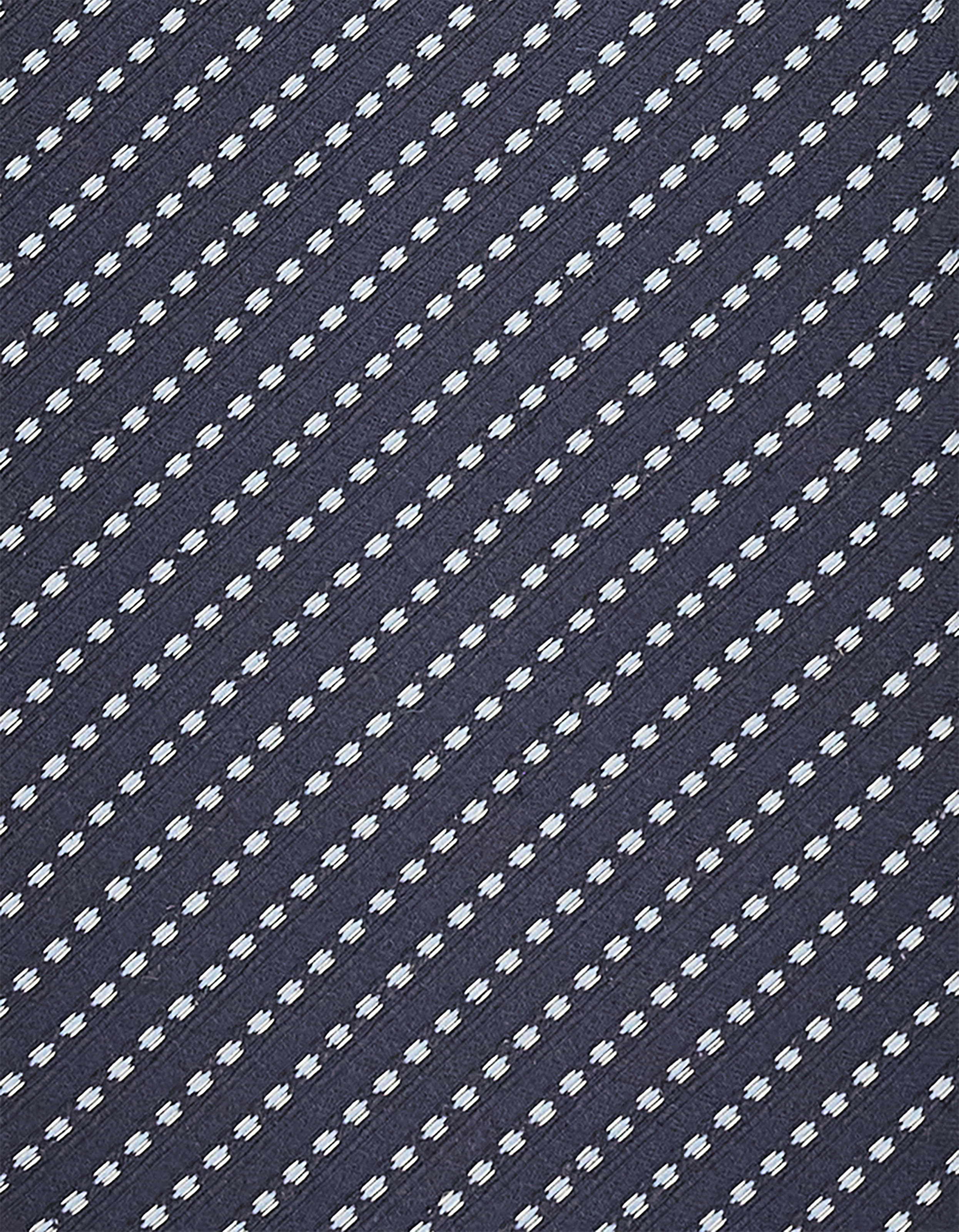 Close view of the jacquard pattern and hand-finished eyelet stitching