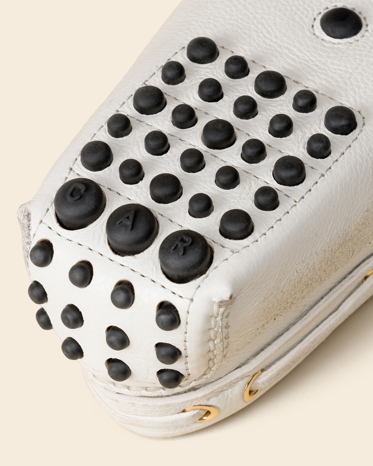 Closeup of the fringe, eyelets, and hand stitching