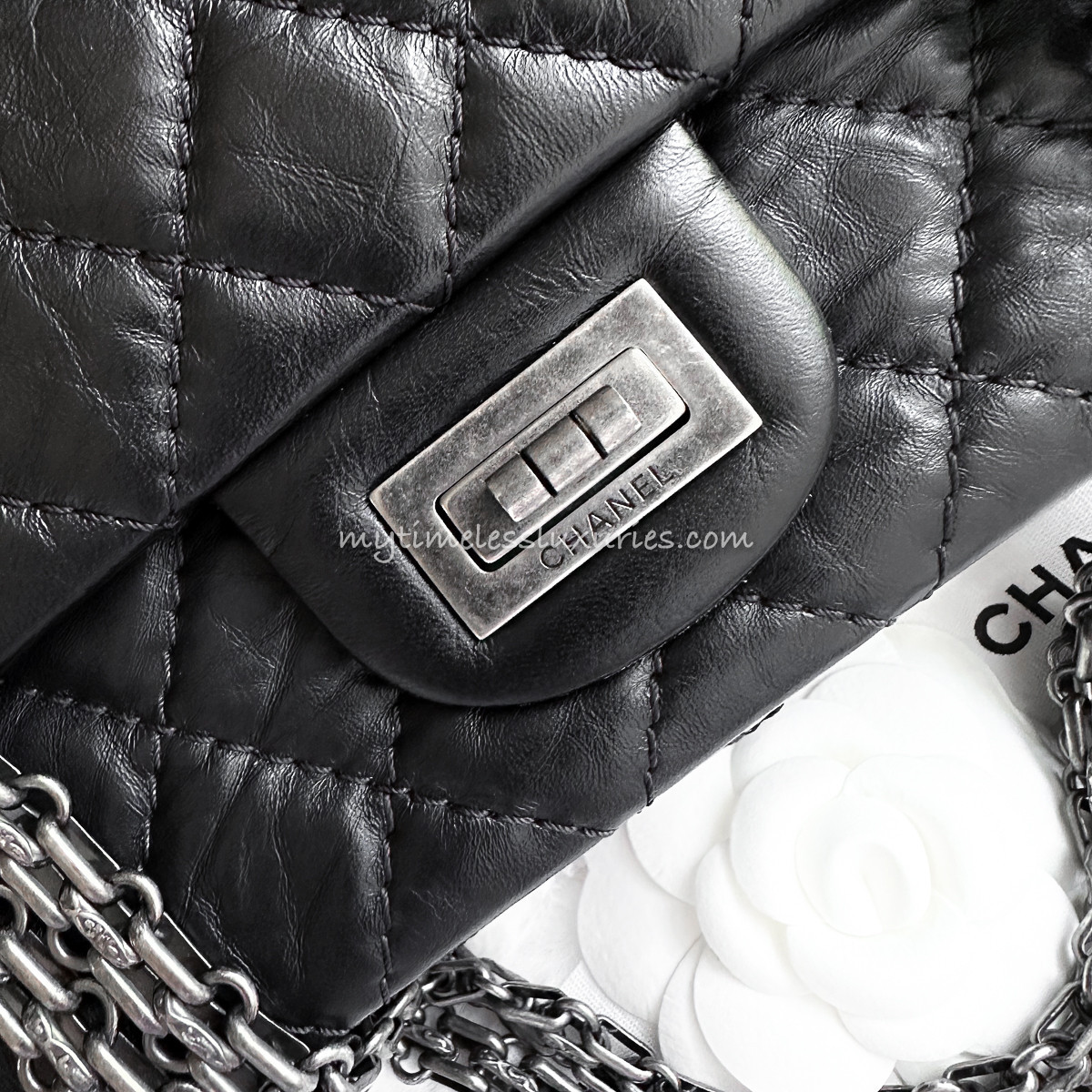 Detail of the rectangular Mademoiselle turnlock and bijoux chain