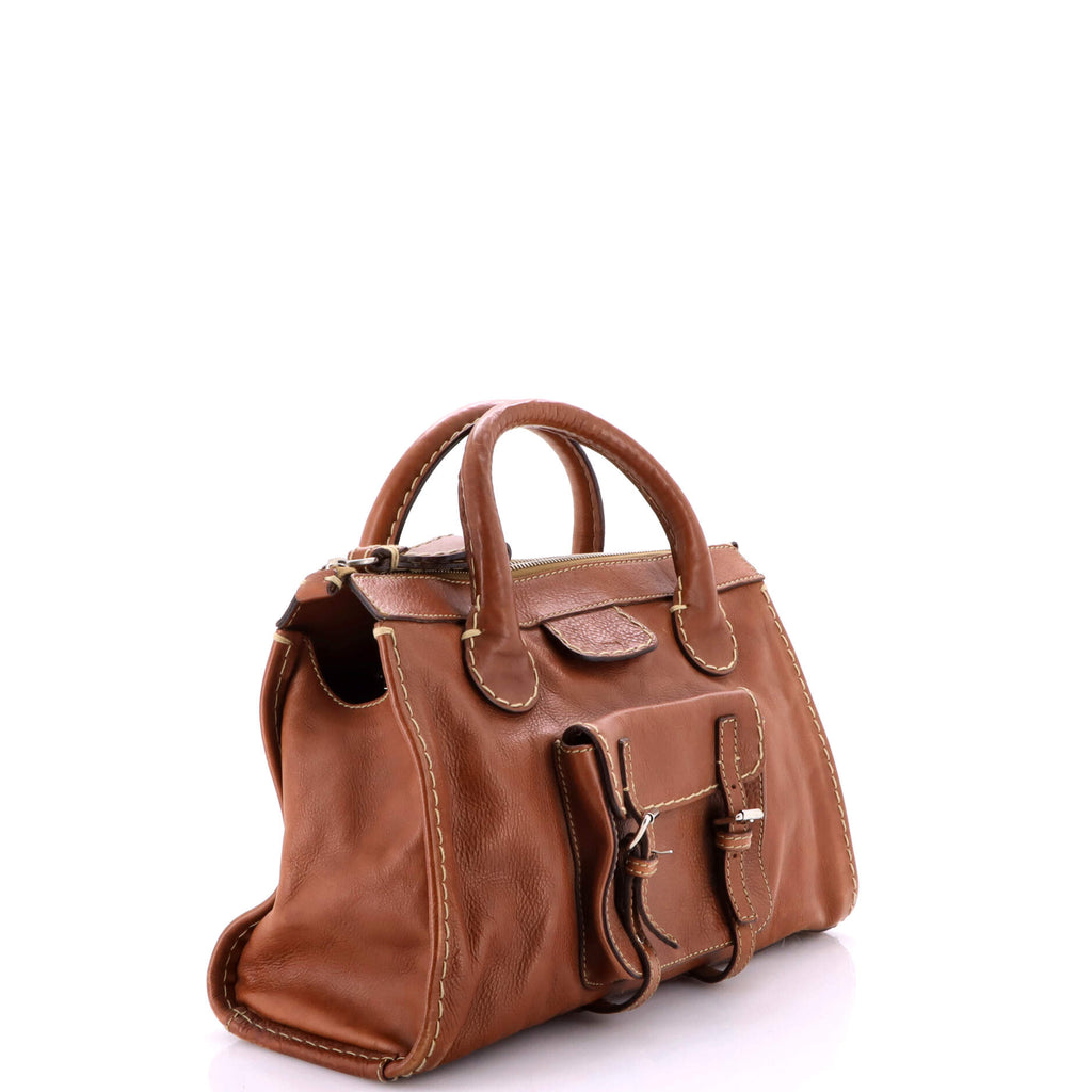 Side profile — rolled handles and front buckle pocket