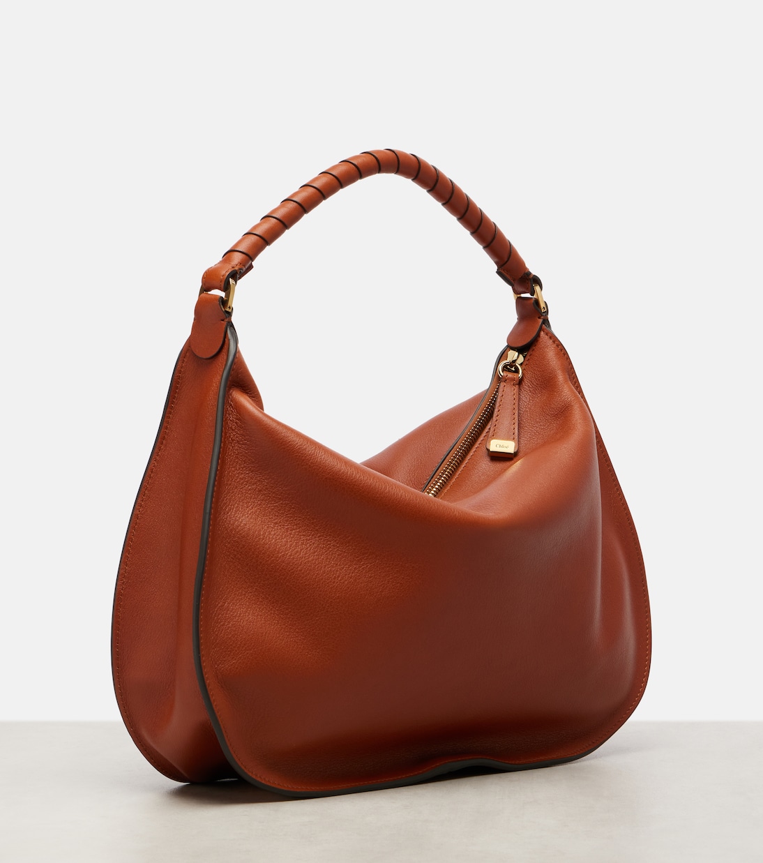 Side profile showing the curved hobo silhouette
