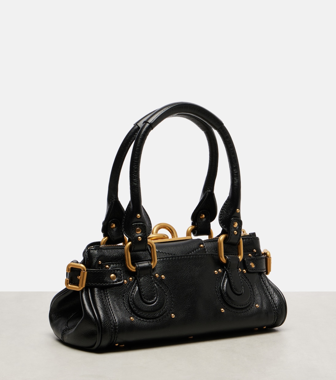 Side profile — the slouchy, studded body and rolled handles