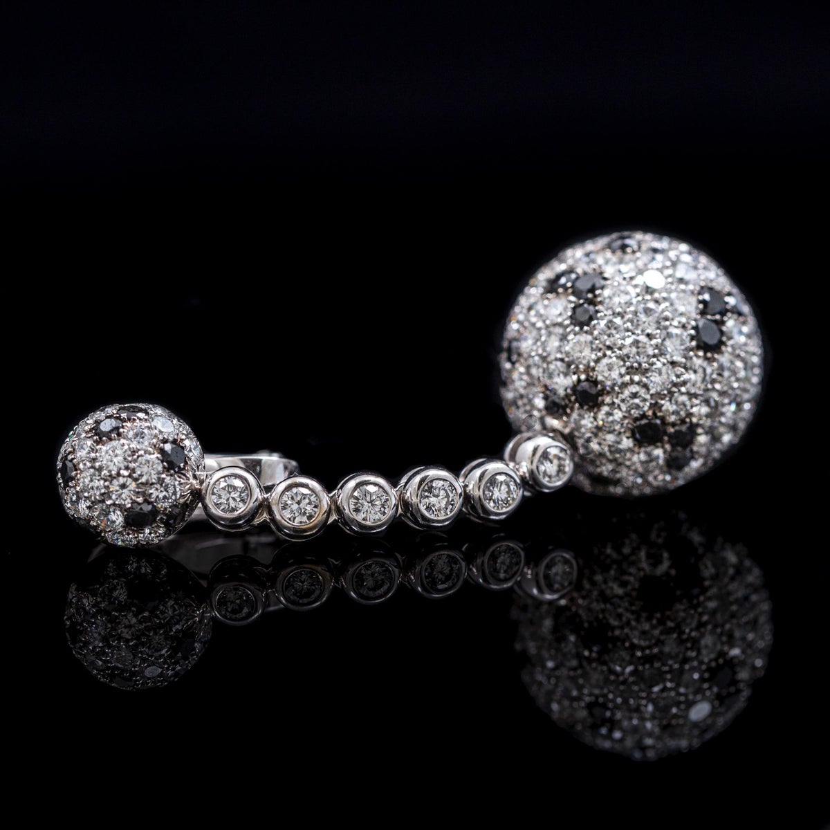 Single earring profile on a dark reflective surface