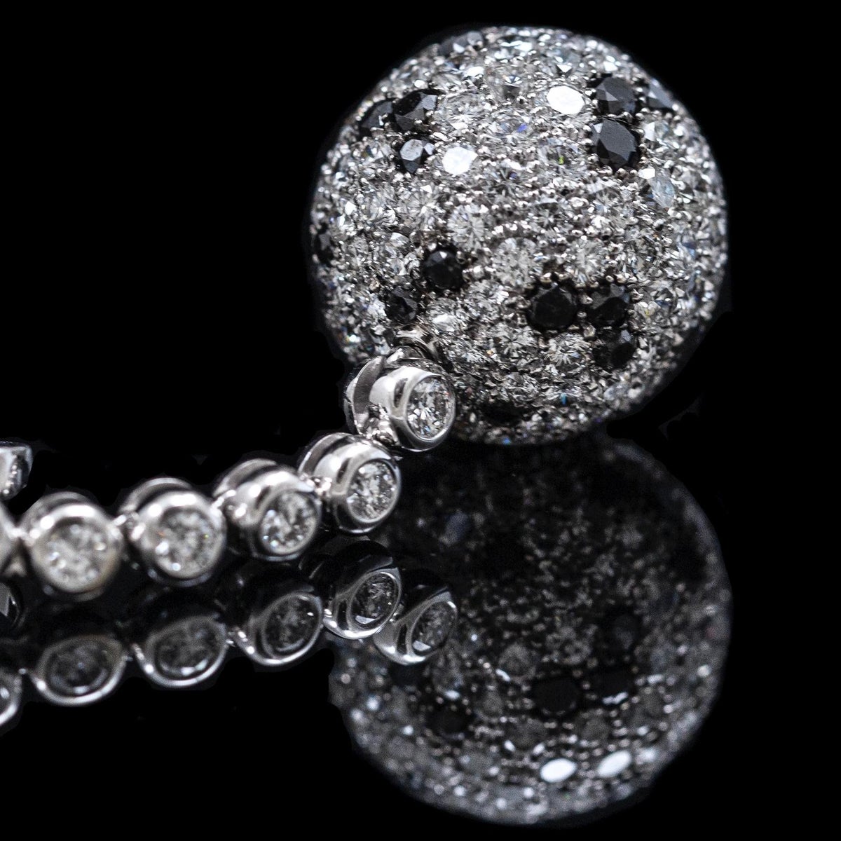 Pavé sphere detail with colourless and black diamonds
