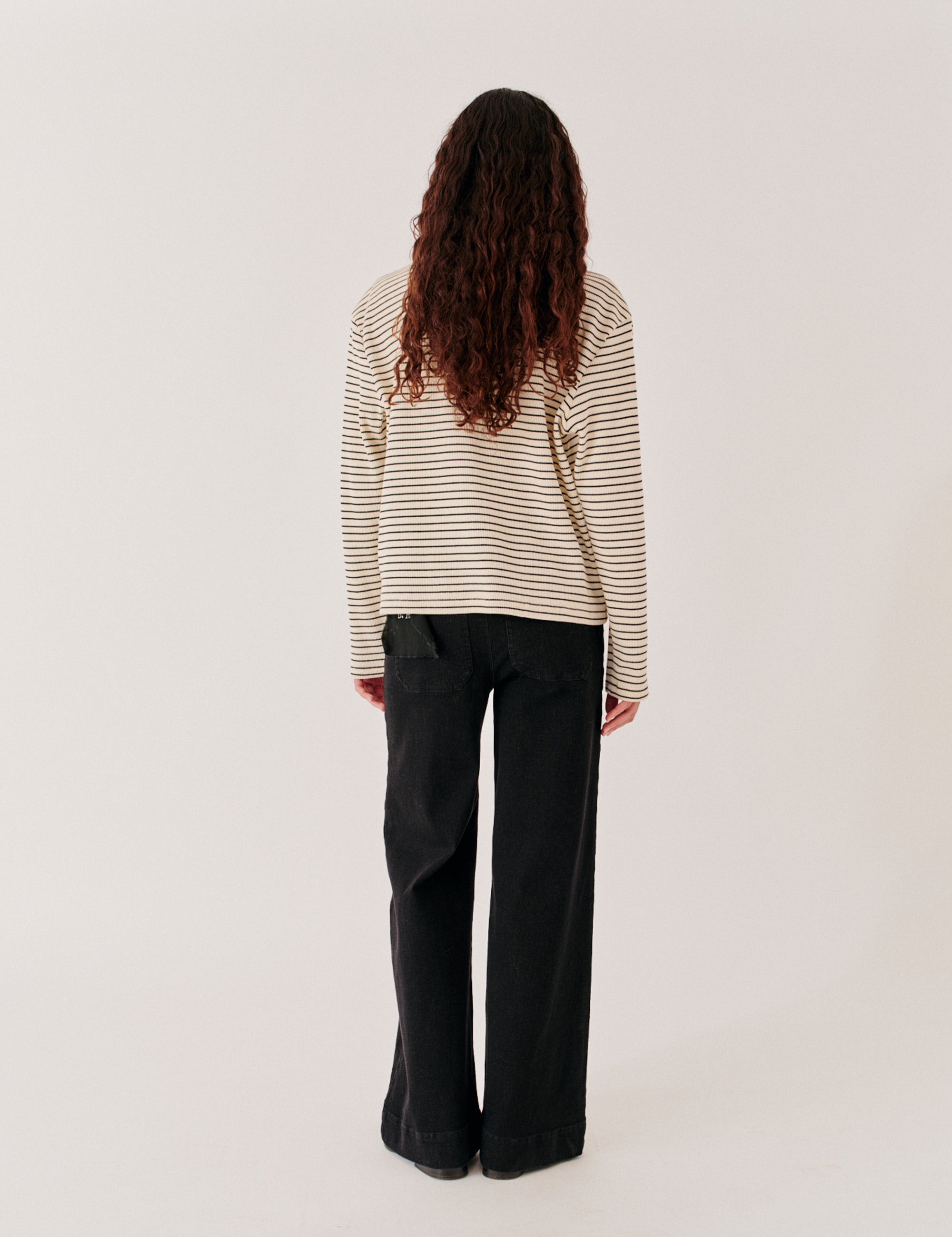 Washed black denim back view