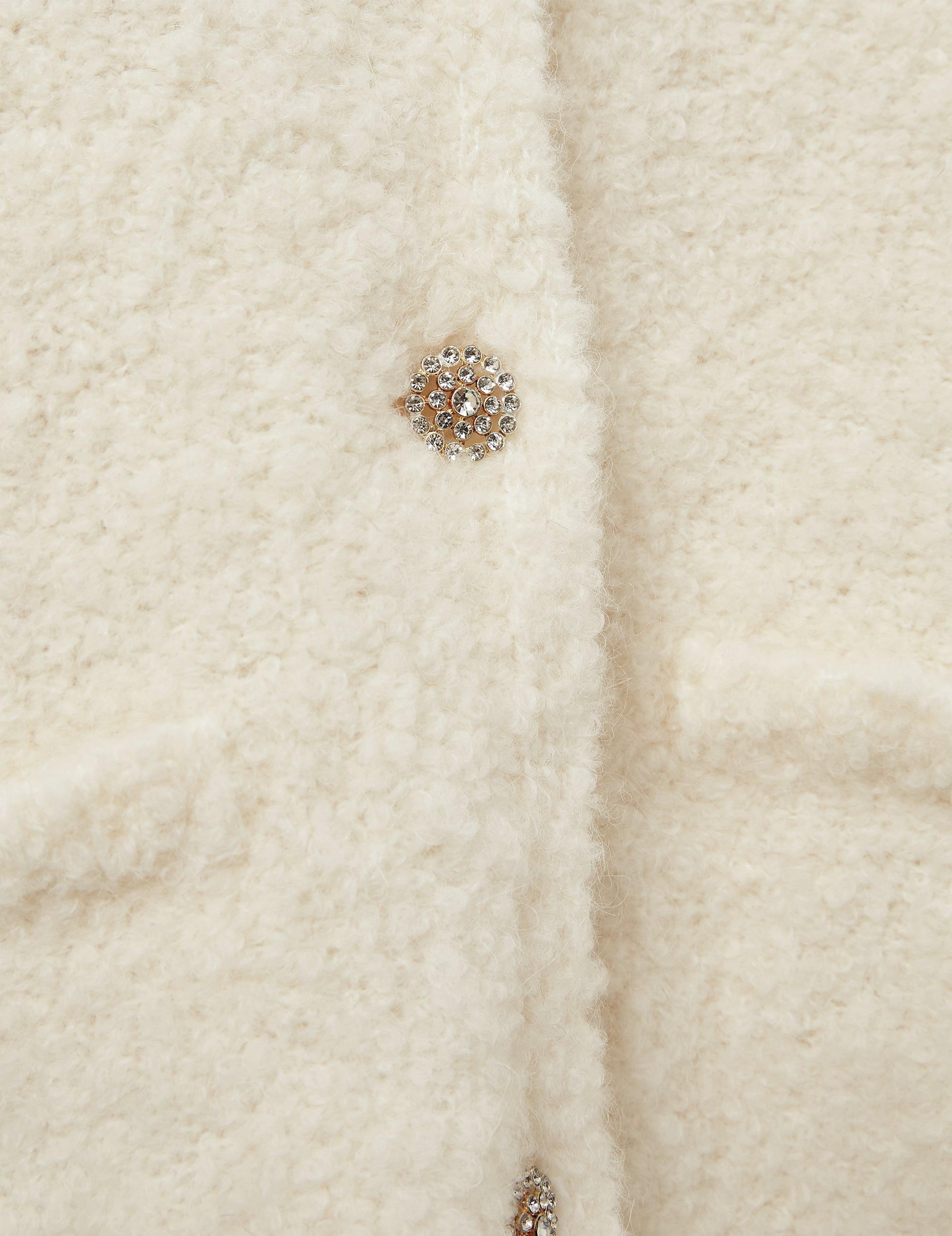 Close-up of bouclé texture and button detail