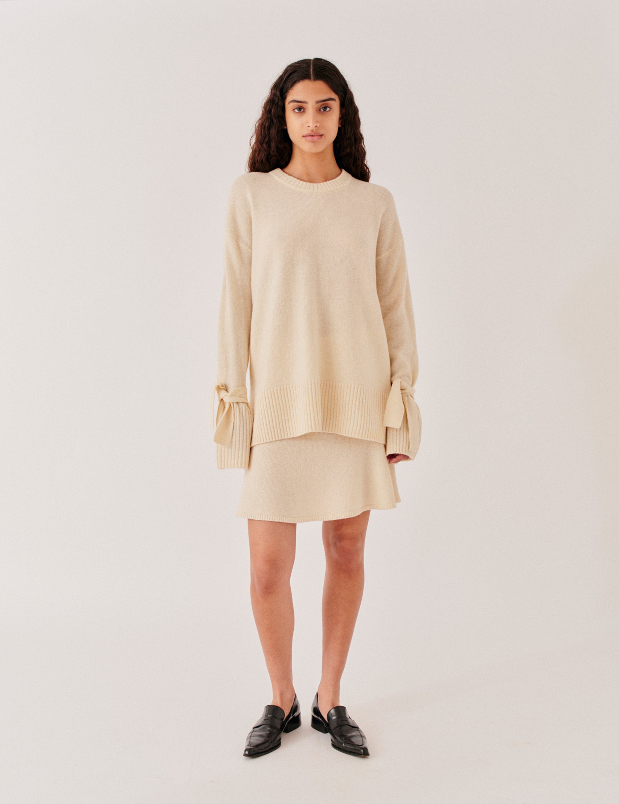 Front view with bow-tied bishop sleeves