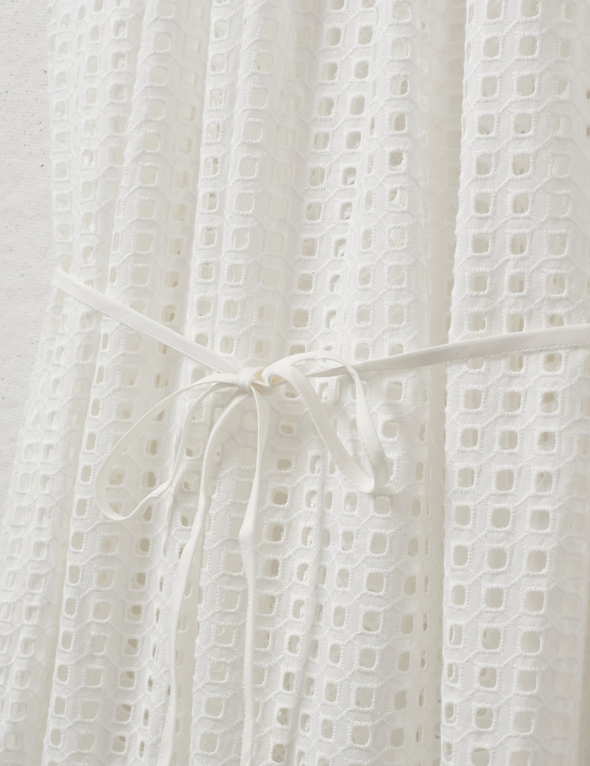 Close-up of the textured fabric and tie waist