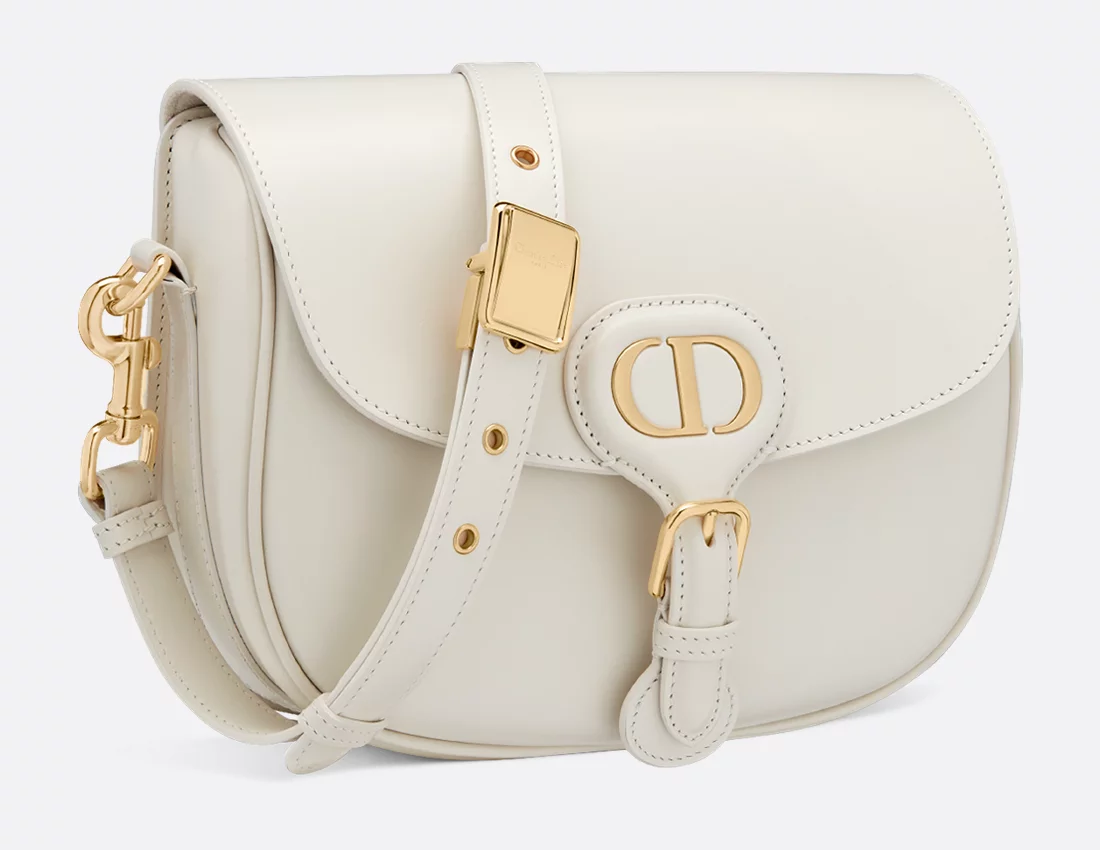 Ivory three-quarter view — the crescent body and gold buckle