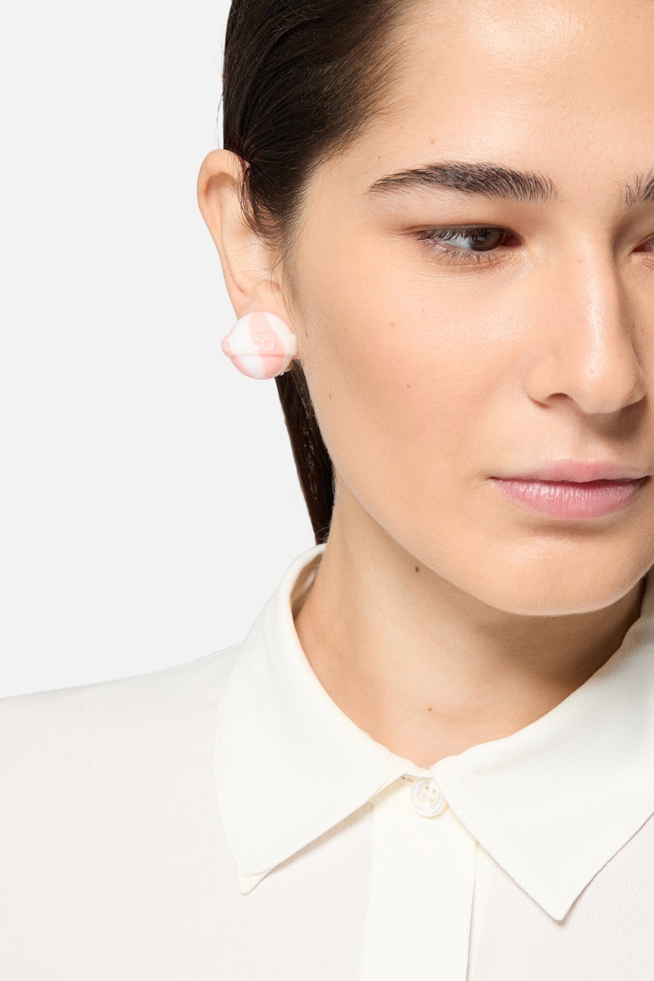 clip-on earrings worn with a clean collar