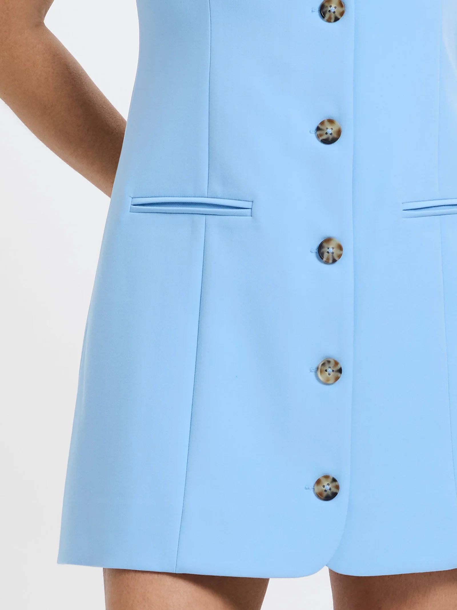 Button and pocket detail in structured twill
